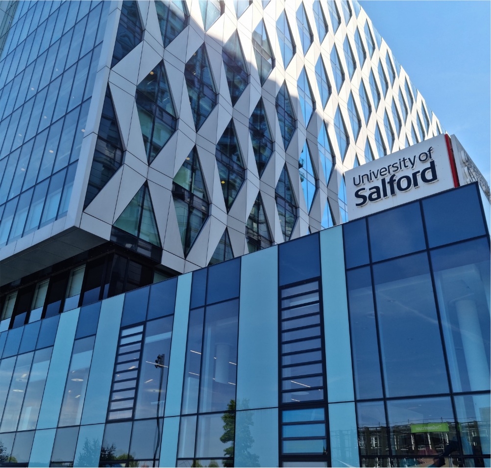 University of Salford campus building with its distinctive glass façade and university sign